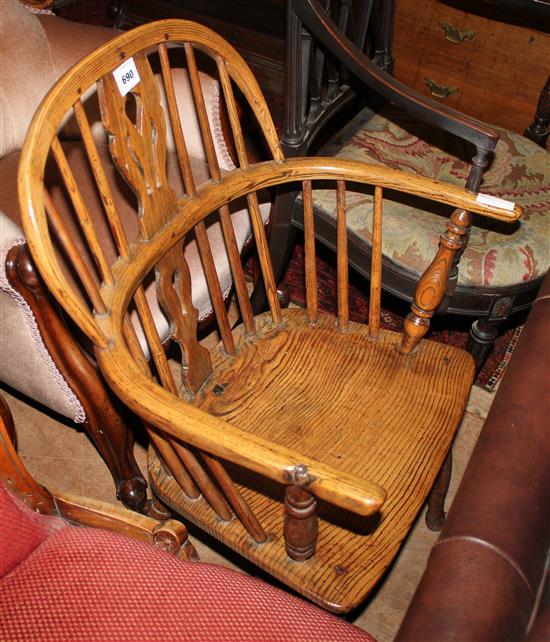 An early 19th century ash and elm hoop back elbow chair